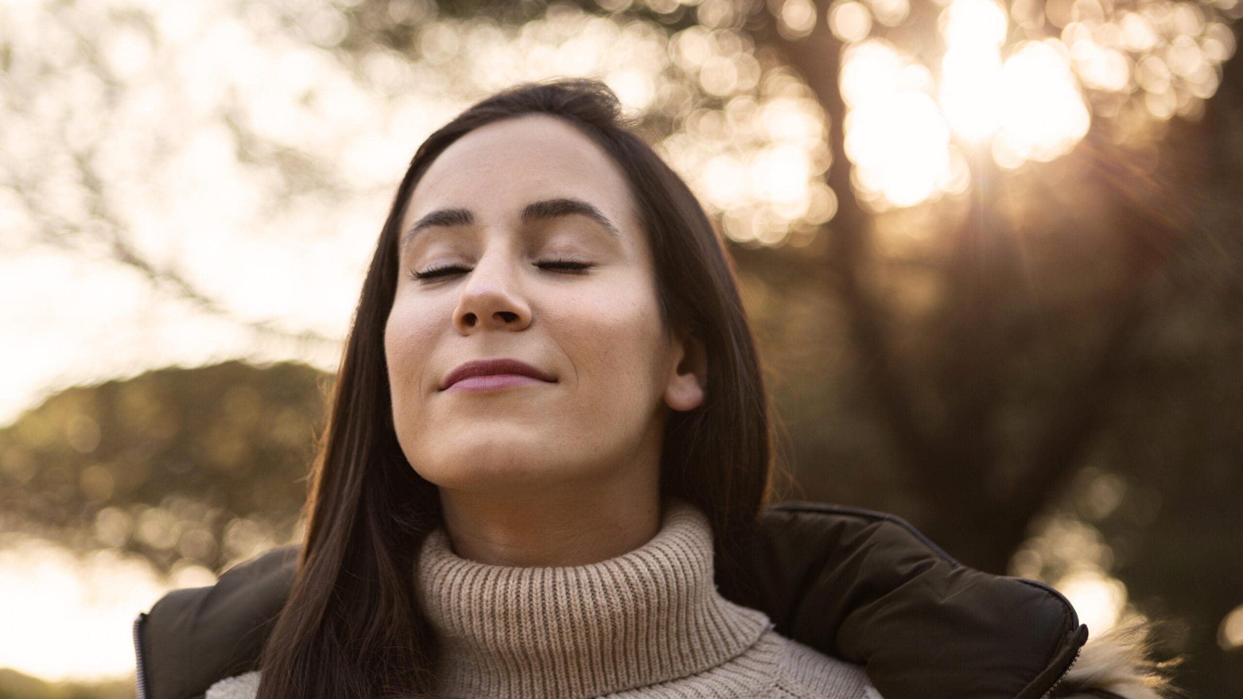 Latina woman feeling safe and at peace after trauma healing, reclaiming pleasure and joy